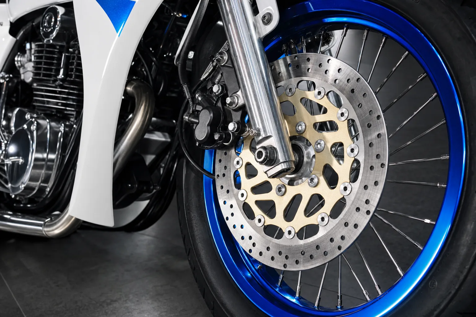 Blue anodised rim against a drilled rotor on a gold carrier